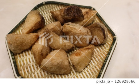 close up of deep fried Taiwanese snacks king trumpet mushroom cut into pieces on a plate 126929366