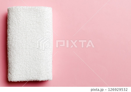 Top view of white towels with copy space on colored background Top view of white towels with copy space on colored background 126929532
