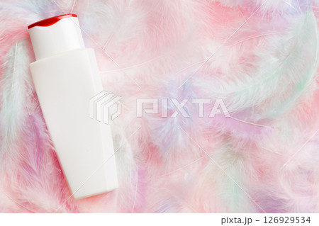 Spa cosmetic product, cream bottle, branding mock up, top view with feathers background. Flat lay 126929534