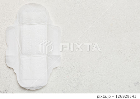 Women hygiene products or sanitary pad on colored background. Pastel color. Closeup. Empty place for text. Female daily hygiene Women hygiene products or sanitary pad on colored background. Pastel color. Closeup. Empty place for text. Female daily hygiene 126929543