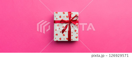 Background with gift box and hearts on pink Background. Top view with copy space for text 126929571