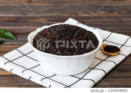 quinoa seeds in bowl and spoon on colored background. Healthy kinwa in small bowl. Healthy superfood 126929605