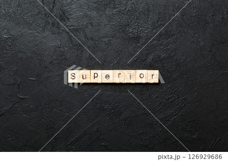 SUPERIOR word written on wood block. SUPERIOR text on cement table for your desing, concept 126929686