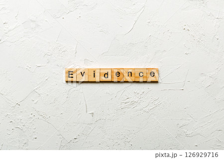 evidence word written on wood block. evidence text on table, concept 126929716