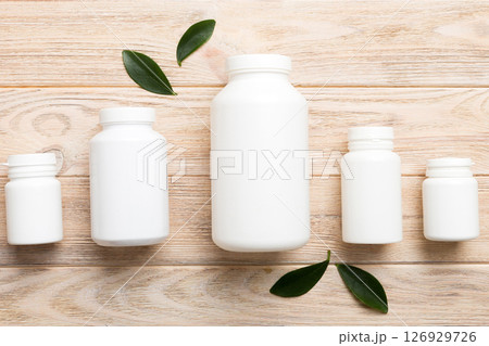 supplement pills with medicine bottle health care and medical top view. Vitamin tablets. Top view mockup bottle for pills and vitamins with green leaves, natural organic bio supplement, copy space supplement pills with medicine bottle health care and medical top view. Vitamin tablets. Top view mockup bottle for pills and vitamins with green leaves, natural organic bio supplement, copy space 126929726