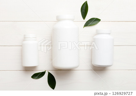 supplement pills with medicine bottle health care and medical top view. Vitamin tablets. Top view mockup bottle for pills and vitamins with green leaves, natural organic bio supplement, copy space supplement pills with medicine bottle health care and medical top view. Vitamin tablets. Top view mockup bottle for pills and vitamins with green leaves, natural organic bio supplement, copy space 126929727