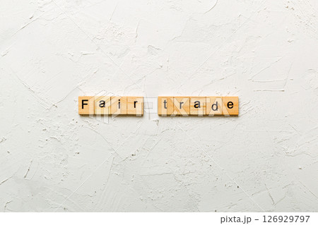 fair trade word written on wood block. fair trade text on cement table for your desing, concept fair trade word written on wood block. fair trade text on cement table for your desing, concept 126929797