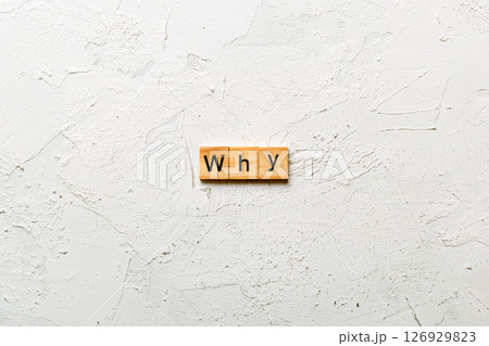 WHY word written on wood block. WHY text on cement table for your desing, concept WHY word written on wood block. WHY text on cement table for your desing, concept 126929823