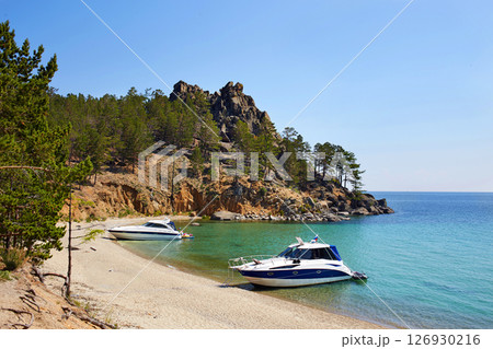 The beautiful sandy beach on summer sunny day. Yachts near the shore. Lake Baikal, the Sandy Bay. 126930216