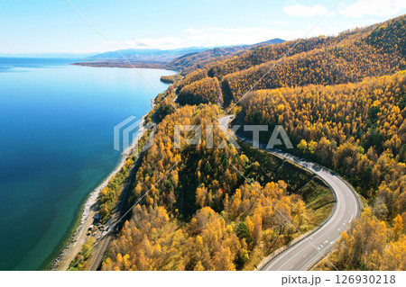 Serpentine highway along the lake. Beautiful autumn landscape from the air 126930218