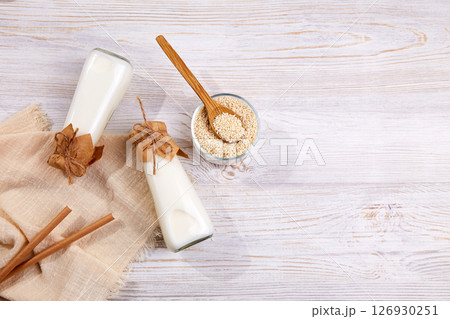 Sesame milk in bottles, sesame seeds in a jar 126930251