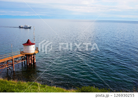 Lake Baikal on a summer day. Listvyanka village. The ship transports tourists. Lake Baikal on a summer day. Listvyanka village. The ship transports tourists. 126930255