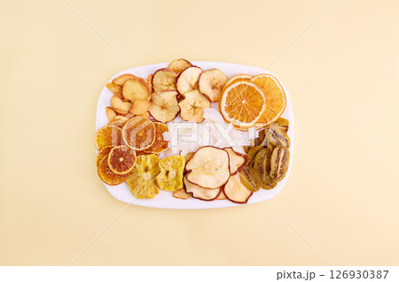 Dried apple, pear, pineapple,kiwi,apricot, coconut, orange and mandarin chips 126930387