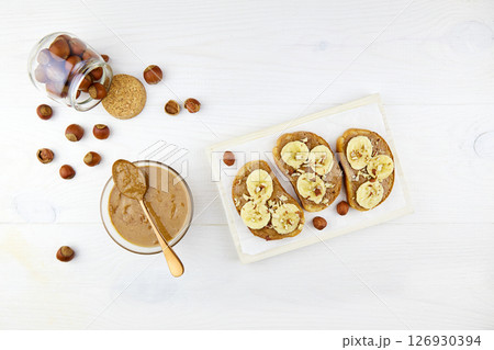Homemade raw organic hazelnut paste. Toasts with hazelnut butter and banana Homemade raw organic hazelnut paste. Toasts with hazelnut butter and banana 126930394