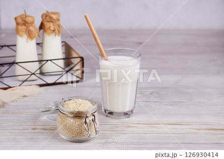 Sesame milk in bottles and a glass, sesame seeds in a jar Sesame milk in bottles and a glass, sesame seeds in a jar 126930414