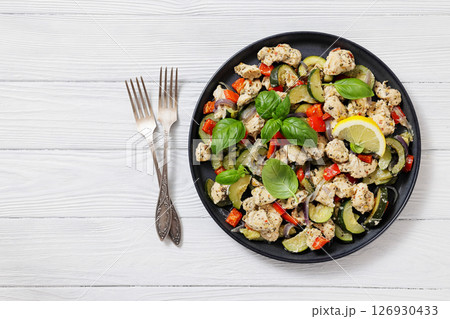 baked italian chicken and vegetables on a plate baked italian chicken and vegetables on a plate 126930433