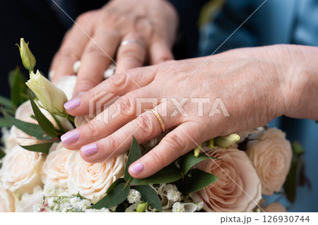 Married mature old couple holding hands with rings ceremony wedding day Married mature old couple holding hands with rings ceremony wedding day 126930744