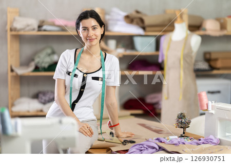 woman dressmaker stands in the workshop woman dressmaker stands in the workshop 126930751