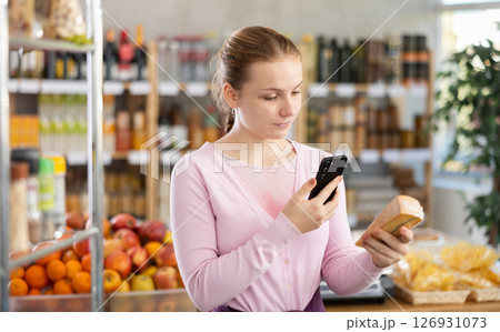 Young girl scanning qr code for cheese 126931073