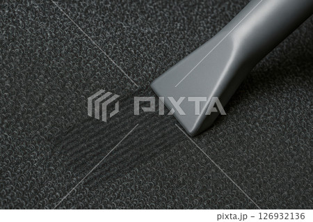 Vacuum cleaner nozzle deep cleans dark carpet fibers, removing dirt and leaving a noticeable clean path with textured detail, AI Generative 126932136