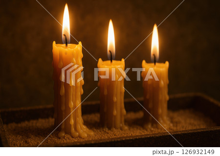 Burning orthodox religious candles with melting wax drips illuminating a serene spiritual atmosphere during reflection or prayer, AI Generative 126932149