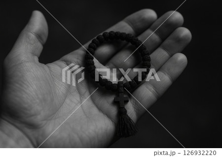 Orthodox christian prayer rope with cross resting in open palm, symbolizing faith, devotion, meditation, and spiritual tradition, AI Generative 126932220