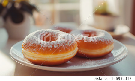 Classic donuts with powdered sugar served on white plate 126932312