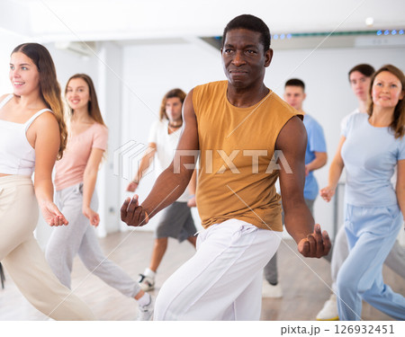 People practicing group dancing in fitness center 126932451