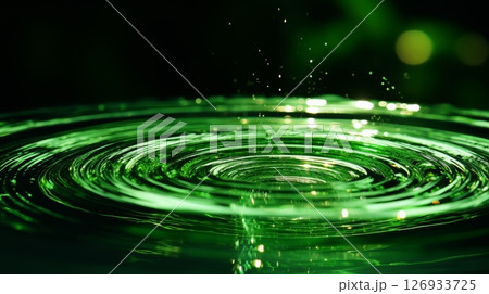 Concentric circles formed by water droplet on phosphorescent surface in close up view 126933725