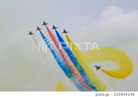 J-10 Acrobatic airshow team from China Air Force on formations with colorful smokes venting from the plane. J-10 Acrobatic airshow team from China Air Force on formations with colorful smokes venting from the plane. 126934148