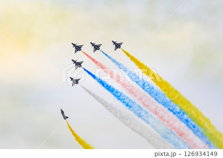 J-10 Acrobatic airshow team from China Air Force on formations with colorful smokes venting from the plane. J-10 Acrobatic airshow team from China Air Force on formations with colorful smokes venting from the plane. 126934149