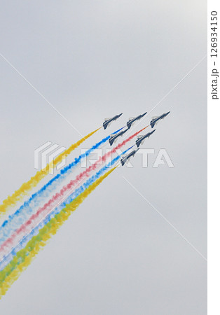 J-10 Acrobatic airshow team from China Air Force on formations with colorful smokes venting from the plane. 126934150