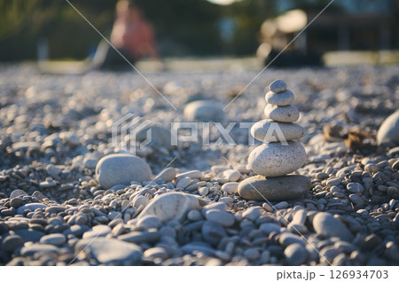 Balancing Rocks Stacked on a Pebble Beach with a Serene Background Balancing Rocks Stacked on a Pebble Beach with a Serene Background 126934703