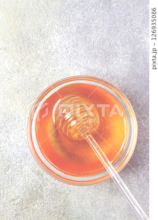 spoon with honey, on the table, spindle for honey, close-up, rustic view, spoon with honey, on the table, spindle for honey, close-up, rustic view, 126935086