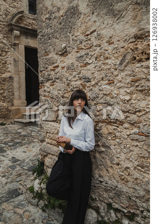 Young Women in White Shirt Reading Book In Vintage Hamlet 126938002