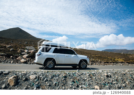 Sichuan,China - August 25,2024 ,Driving Toyota off road car on the high altitude grassland mountains 126940088