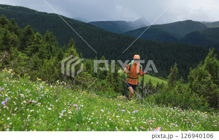 Hiker hiking on high altitude mountain top 126940106