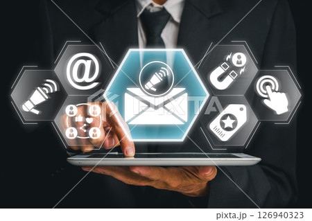 Professional using tablet for e-mail marketing with digital icons and modern technology interface. Professional using tablet for e-mail marketing with digital icons and modern technology interface. 126940323