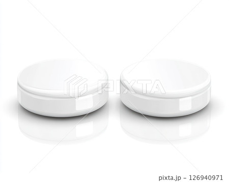 Two white round cosmetic containers with lids on a surface Two white round cosmetic containers with lids on a surface 126940971