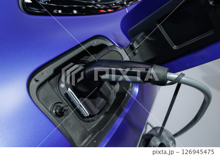 Plugin EV charging for electric car green power sustainable energy source zero emission vehicle Plugin EV charging for electric car green power sustainable energy source zero emission vehicle 126945475