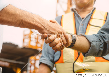 Workers team hand shaking deal with contractor happy at construction site. Project business contact Workers team hand shaking deal with contractor happy at construction site. Project business contact 126945484