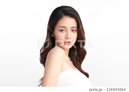 A beautiful young Asian woman with clean, fresh skin against a white background. Skincare, facial treatment, cosmetology, beauty, and spa. An elegant portrait of an Asian woman. 126945664