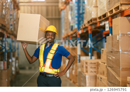 happy warehouse worker carrying lifting products container box for shipping in cargo industry 126945791