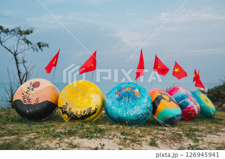 Painted traditional Vietnamese boats and flags of Vietnam in Murals Paintings Fishing Village in Tam Thanh 126945941