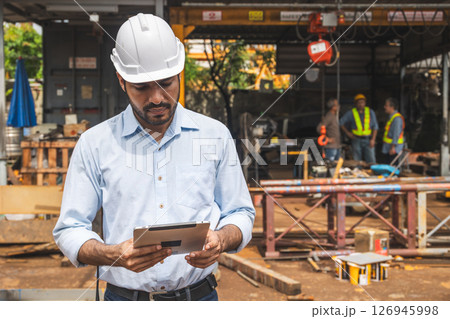 Portrait Hispanic Indian construction engineer male worker at construction site with safety hard hat 126945998