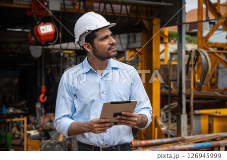 Portrait Hispanic Indian construction engineer male worker at construction site with safety hard hat 126945999