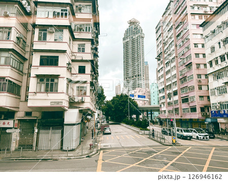 Exterior View Of Old Residential Apartments And Traffic On The Street In Kowloon, Hong Kong. Exterior View Of Old Residential Apartments And Traffic On The Street In Kowloon, Hong Kong. 126946162