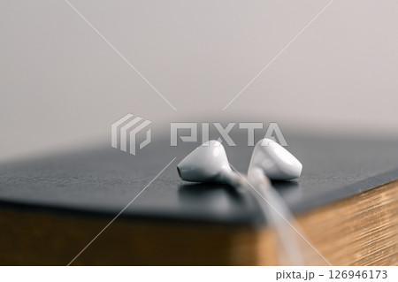 Close-up religious technology headphones pray bible church laptop Jesus Christ Holy Spirit Sunday service spiritual power blur background phone concept heaven belief gospel faith praise worship god 126946173