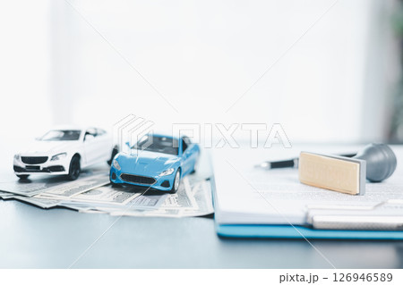 Approved car loan application with car key, rubber stamp and calculator concept. financial document on wooden table. Asset approval purchases to buy car. Ideas for car buying checklist loan tax 126946589