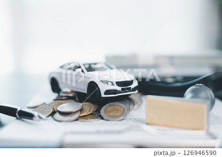 Approved car loan application with car key, rubber stamp and calculator concept. financial document on wooden table. Asset approval purchases to buy car. Ideas for car buying checklist loan tax 126946590